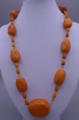 A Vintage amber necklace consisting of thirty-two butterscotch-coloured beads. 55 cm long. 45.