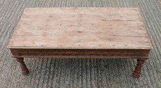 An Eastern carved wooden coffee table. 119 cm long.