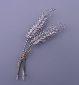 An 18 ct gold diamond set wheatsheaf brooch. 9.5 cm high. 14.4 grammes total weight.