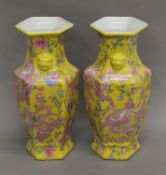 A pair of Chinese porcelain hexagonal yellow ground vases decorated with dragons. 43 cm high.