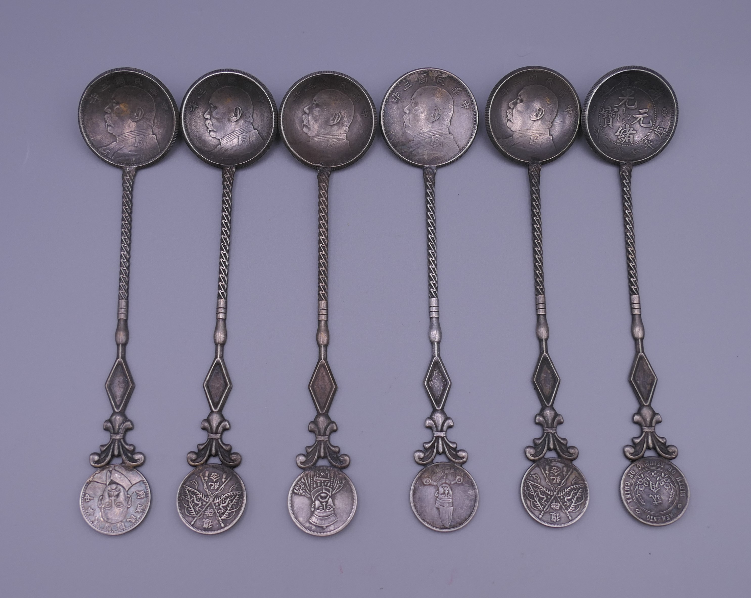 Six Chinese silver coin spoons. 17 cm long.
