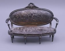 A Dutch silver miniature sofa. 11 cm wide x 7.5 cm high x 4 cm deep. 109.2 grammes.