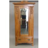 An Art Nouveau satin walnut single mirrored door wardrobe. 97 cm wide.