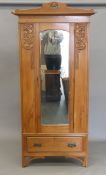 An Art Nouveau satin walnut single mirrored door wardrobe. 97 cm wide.