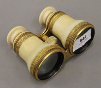 A pair of Victorian ivory mounted opera glasses. 11 cm wide.