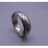 A silver bangle. 6 cm internal diameter. 29.7 grammes.