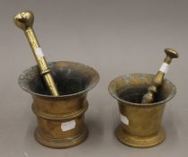 Two antique bronze pestle and mortars. The largest 11 cm high.