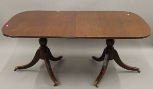 A mahogany twin pillar dining table. 180 cm long x 105 cm wide.