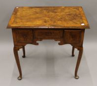 A Georgian walnut lowboy. 75 cm wide, 72 cm high, 48.5 cm deep.