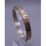 A 9 ct tri-coloured gold bracelet. 7 cm long. 11.6 grammes.