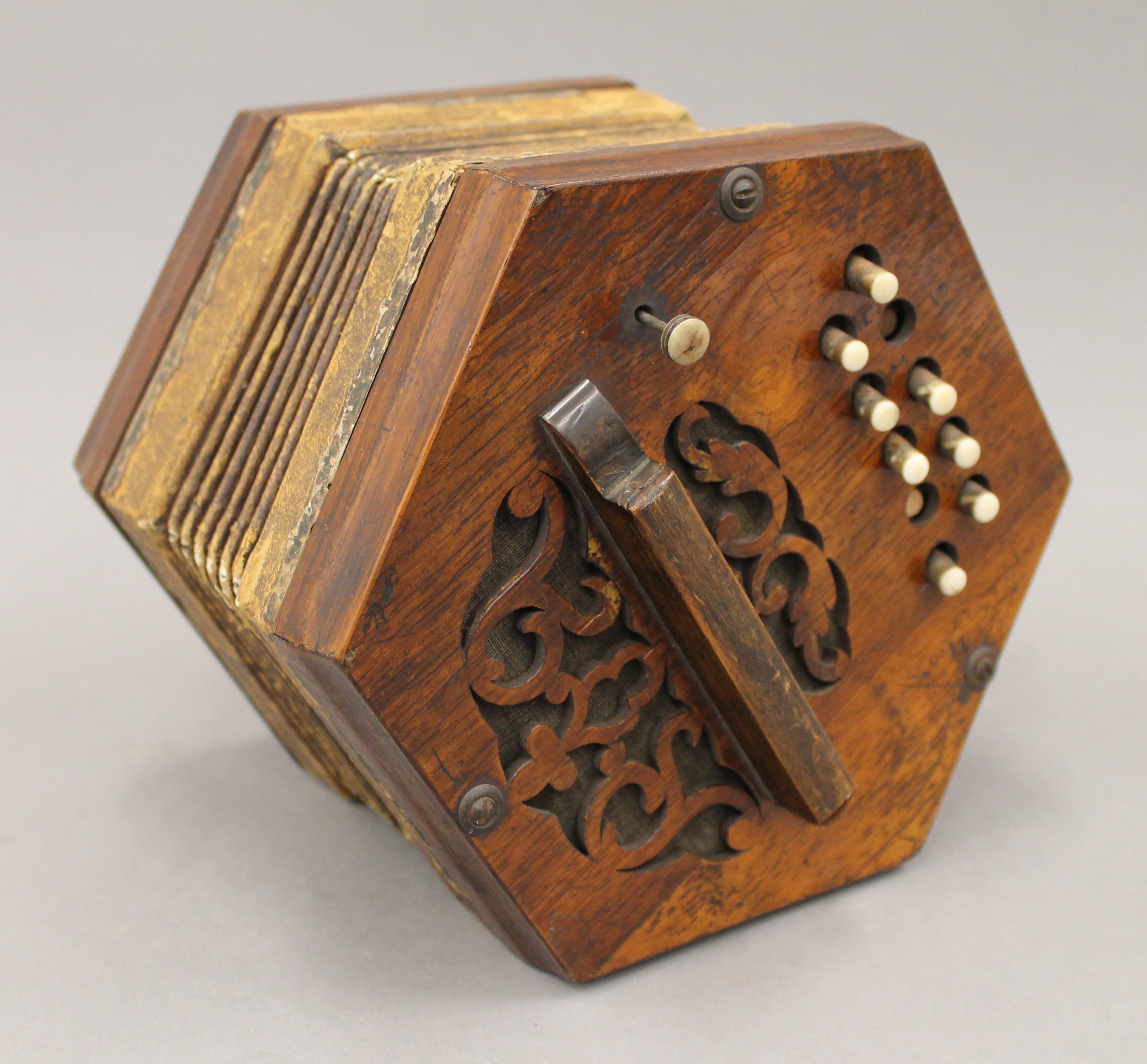 A Victorian rosewood concertina. 19 cm wide.