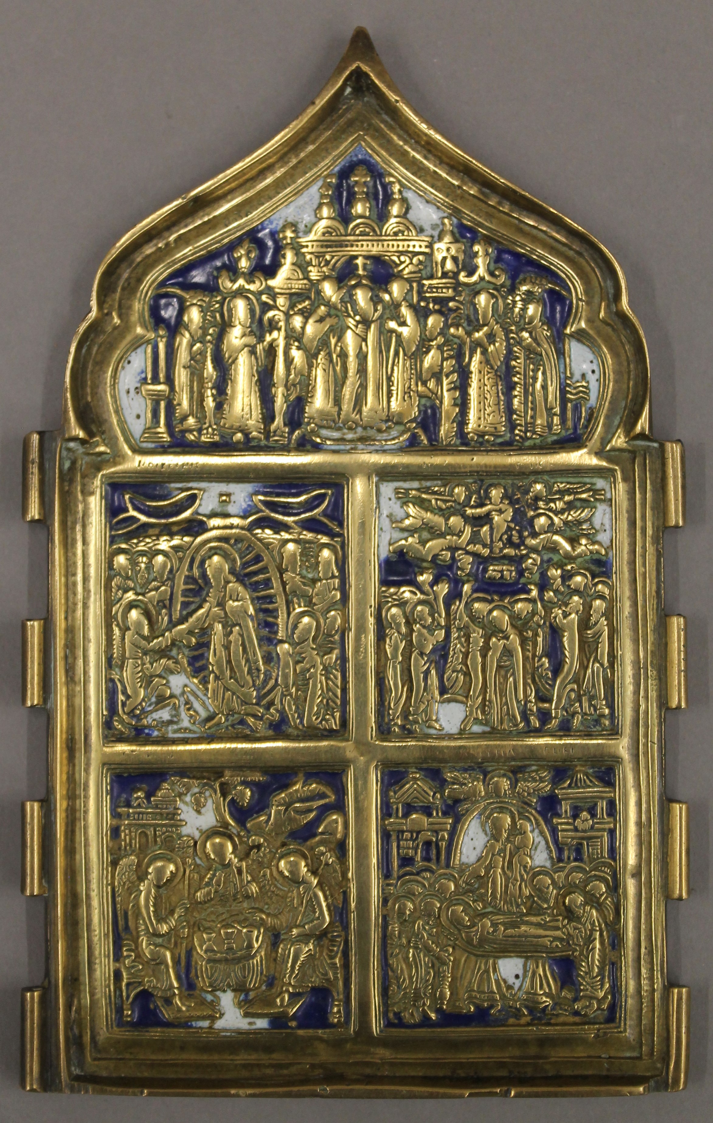 An 18th century Russian brass triptych of typical form with white and blue enamels, lacking sides.