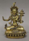 A gilt bronze model of Buddha decorated with coral and turquoise. 21.5 cm high.