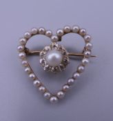 An 18 ct gold, pearl and diamond heart brooch. 2.5 x 2.25 cm. 3.2 grammes total weight.