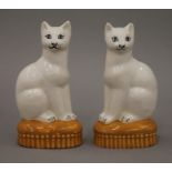 A pair of porcelain models of cats. Each 14 cm high.