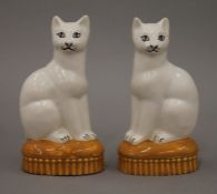 A pair of porcelain models of cats. Each 14 cm high.