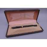 A Dunhill fountain pen with a 14 ct gold nib, boxed. 13.75 cm long.