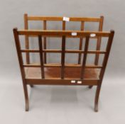 An Edwardian walnut magazine rack.