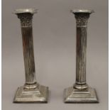 A pair of silver Corinthian column candlesticks. 23 cm high. 1011.9 grammes total weight.