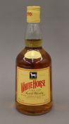 A bottle of White Horse Fine Old Scotch Whisky.