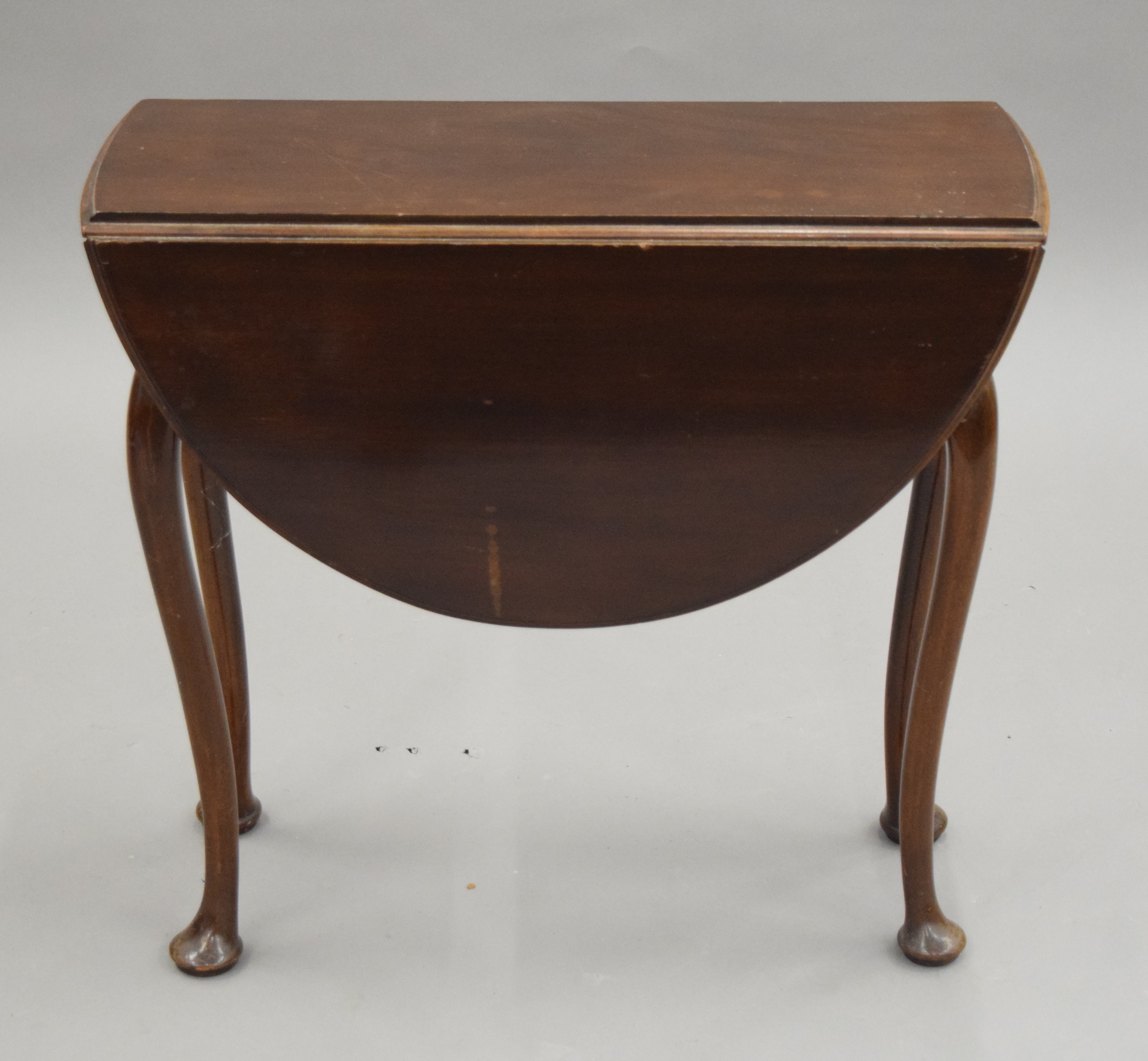 A small early 20th century mahogany drop leaf table. 59.5 cm long.