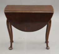 A small early 20th century mahogany drop leaf table. 59.5 cm long.