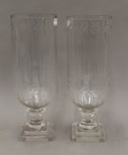 A pair of cut glass storm lamps. 34.5 cm high.