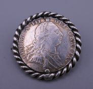 A 1787 sixpence coin brooch. 3 cm diameter.