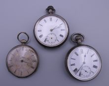 Two silver pocket watches and Islim white metal pocket watch. The latter 4.5 cm wide.