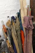 A collection of various vintage fishing rods, including some split cane examples and a keep net.