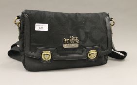 A Coach handbag. 32 cm wide.