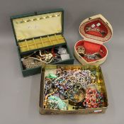 Two jewellery boxes and a large tin of costume jewellery, cufflinks, watches, etc.