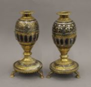 A pair of Eastern 18th/19th century brass and white metal mounted coconut form candlesticks. 24.