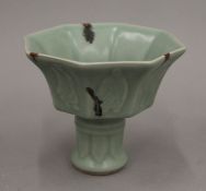 A Chinese celadon ground pottery stem cup. 10.5 cm high.