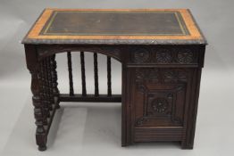A Victorian carved oak desk. 95.5 cm wide.