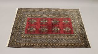 A small red ground rug. 134 cm x 94 cm.