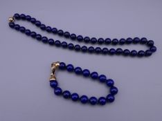 A lapis necklace and a lapis bracelet. The necklace approximately 43 cm long.