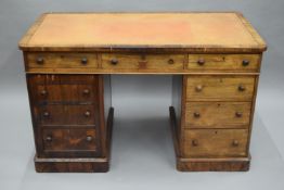 A 19th century rosewood desk, the top with drawers to one side and opposing dummy drawers,