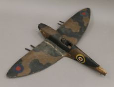 A mid-20th century wooden model of a Spitfire.