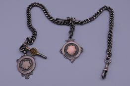 A silver double Albert watch chain with fobs and watch key. 73.2 grammes.