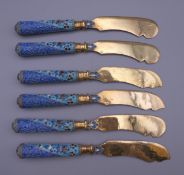 A set of six silver and enamel knives bearing Russian marks. Each 17.5 cm long.