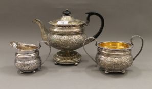 A silver plated three-piece tea set. The tea pot 20 cm high.