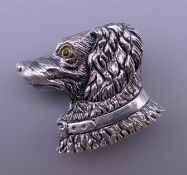 A sterling silver brooch formed as a dog's head. 3 cm high.