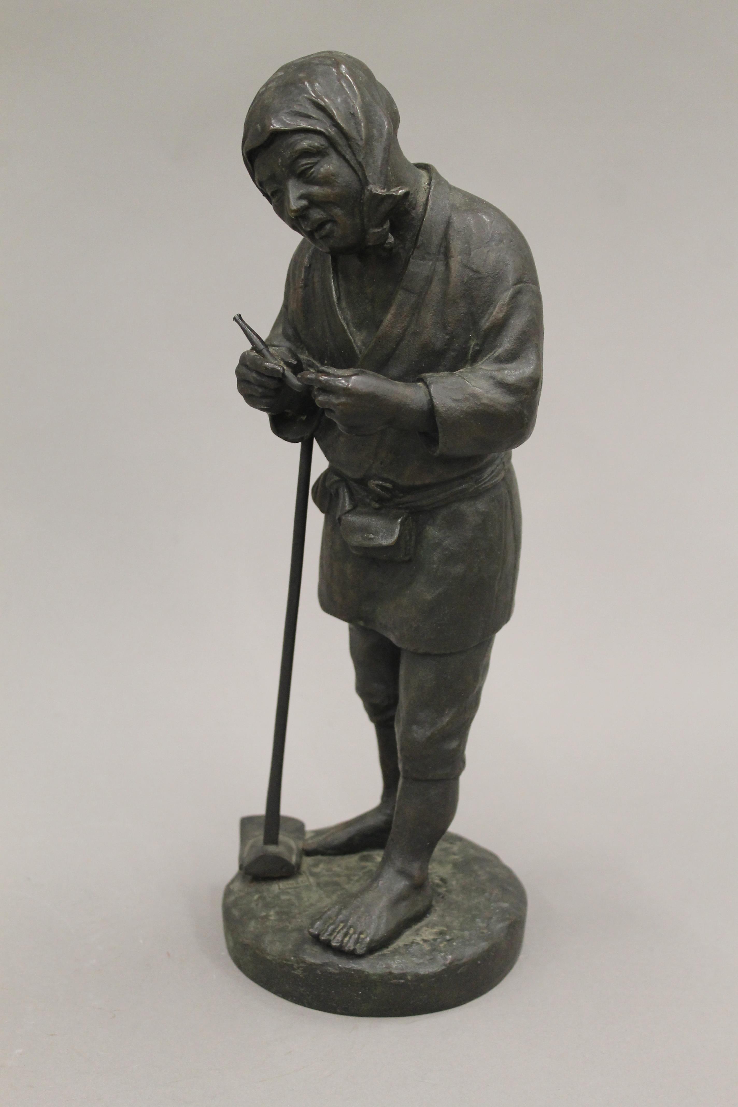 A Japanese Meiji period bronze model of a farmer. 30 cm high. - Image 2 of 4