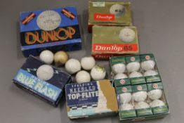 A collection of vintage golf balls, including boxed Dunlop examples.