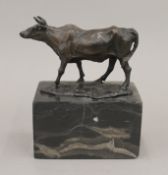 A bronze model of a cow. 15 cm high.