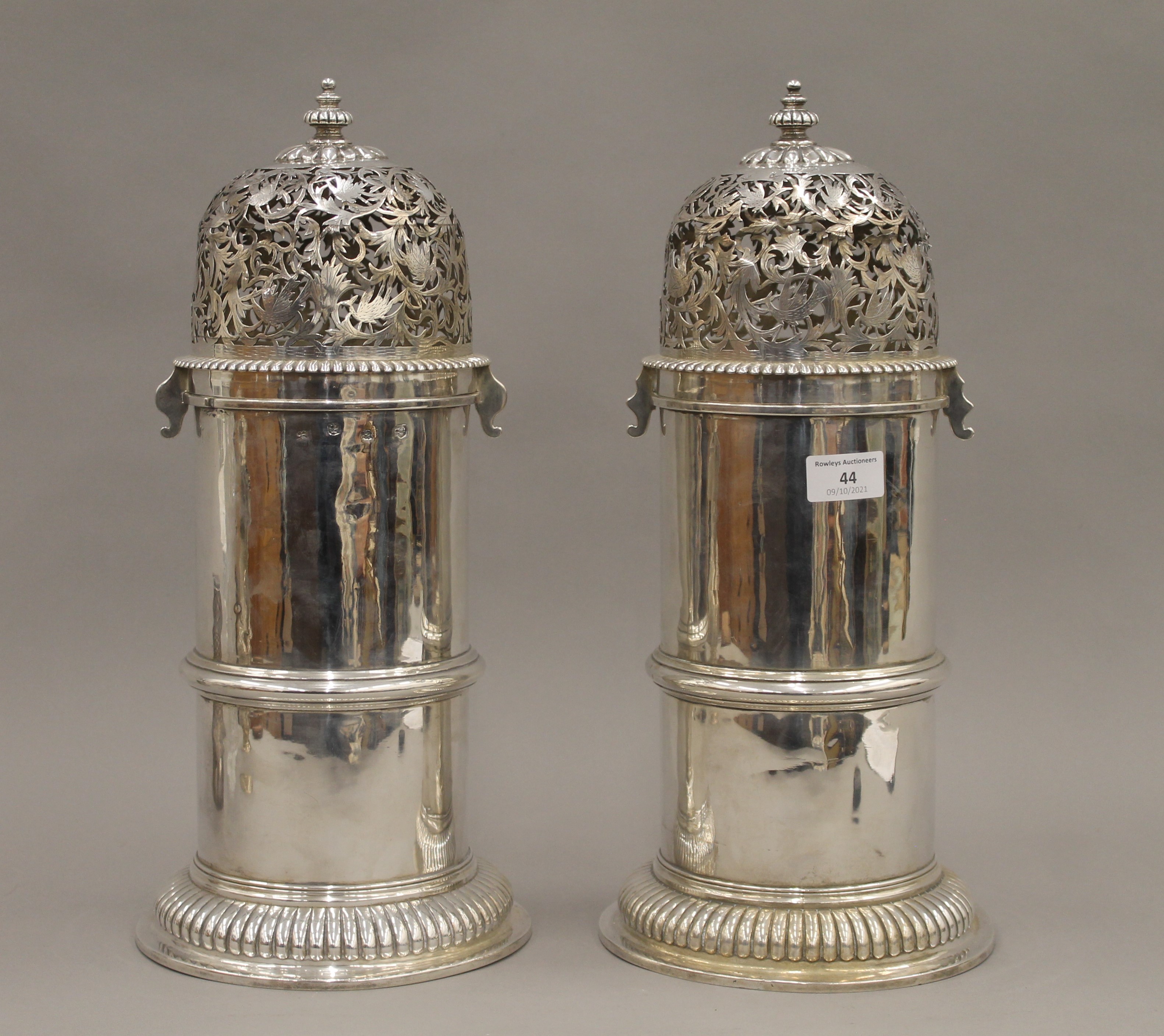 A pair of large silver castors, each with expunged marks and re assay marks. Each 41 cm high. 128.