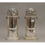 A pair of large silver castors, each with expunged marks and re assay marks. Each 41 cm high. 128.