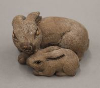 A Japanese carved wooden model of rabbits. 7.5 cm long.