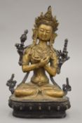 A Tibetan Buddha in typical pose. 21.5 cm high.